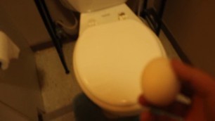 busting an egg in a toilet