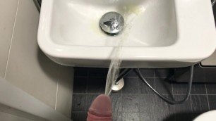 Pissing in to a public sink with powerful piss stream.