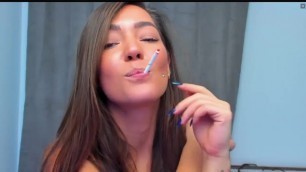 Beautiful cam girl smokes a cigarette