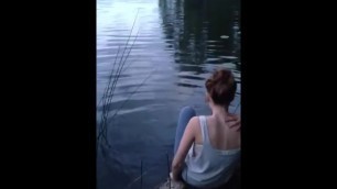 Girls in jeans go swimming in cold lake