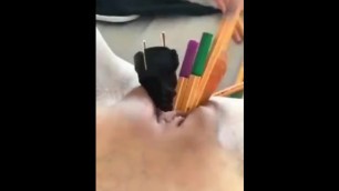 German girl masturbates with pens, carrot and cable