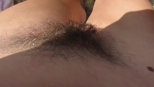 nude milf smoking and caressing hairy pussy