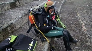 Scuba girl gearing up drysuit