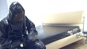 In black full rubber + hazmat suit