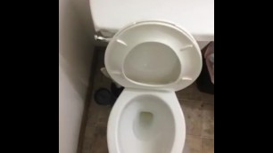 Peeing in toilet struggling, grunting.