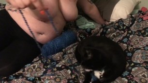 topless woman playing with cat