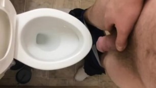 A long piss in the toilet, with grunting
