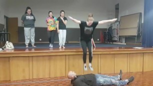 Girls jumping on a guy inside the theater