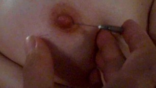 a needle stuck in the nipple. Will she let me drive him deeper and pierce?